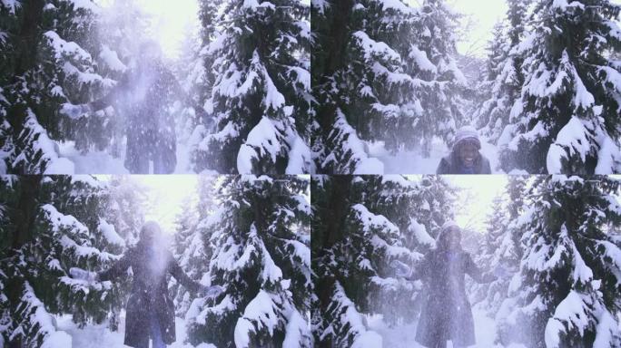 年轻女子在森林里享受雪的乐趣 -- 超级慢动作