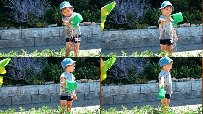 小男孩在家庭花园里浇花