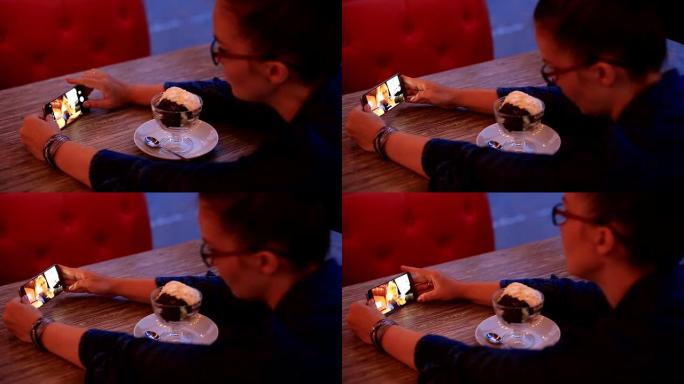 商务女性在咖啡馆用智能手机吃午餐。
