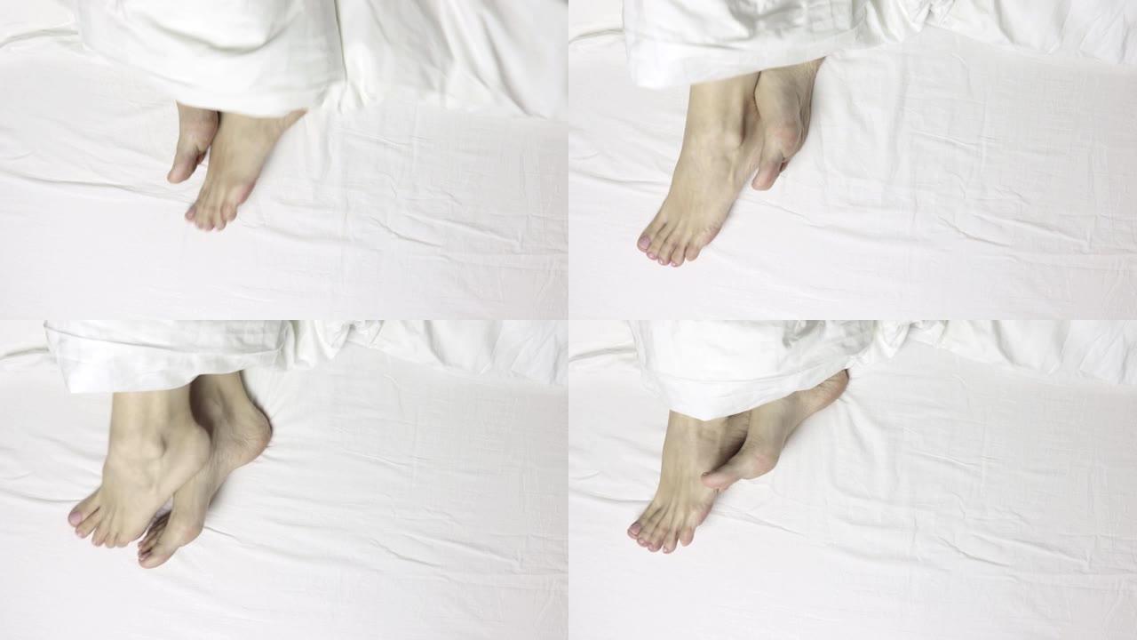 女人腿脚躺在床上，俯视图，早上醒来放松