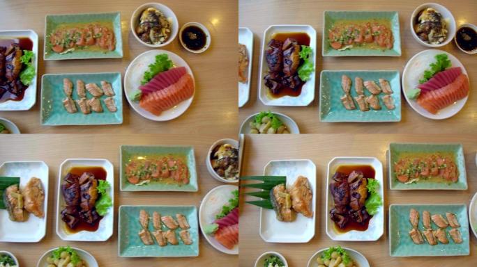 日本餐厅三文鱼、三文鱼烧伤、章鱼烧、鸡肉日本料理的俯视图。