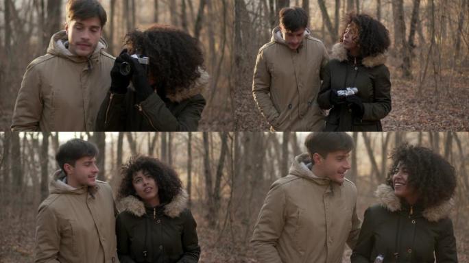 夫妇在寒假期间在森林里散步和拍照