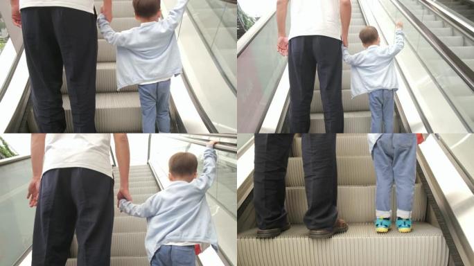 可爱的小亚洲2 -3岁幼儿男婴儿童和爸爸手牵移动自动扶梯的背面