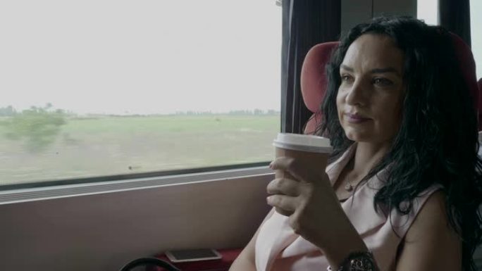 迷人的女商人喜欢坐火车通勤去办公室，坐在窗户附近喝咖啡