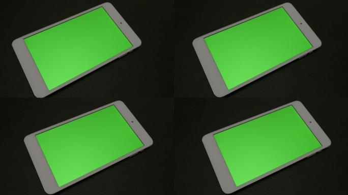 木质表面带绿屏显示的银色桌子缓慢平移4K 3840X2160 UHD镜头-在带有绿屏显示的PC平板电
