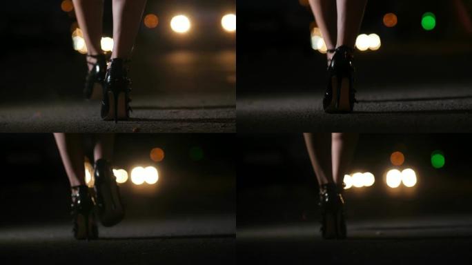 穿着细高跟鞋的女人的脚在夜里行走