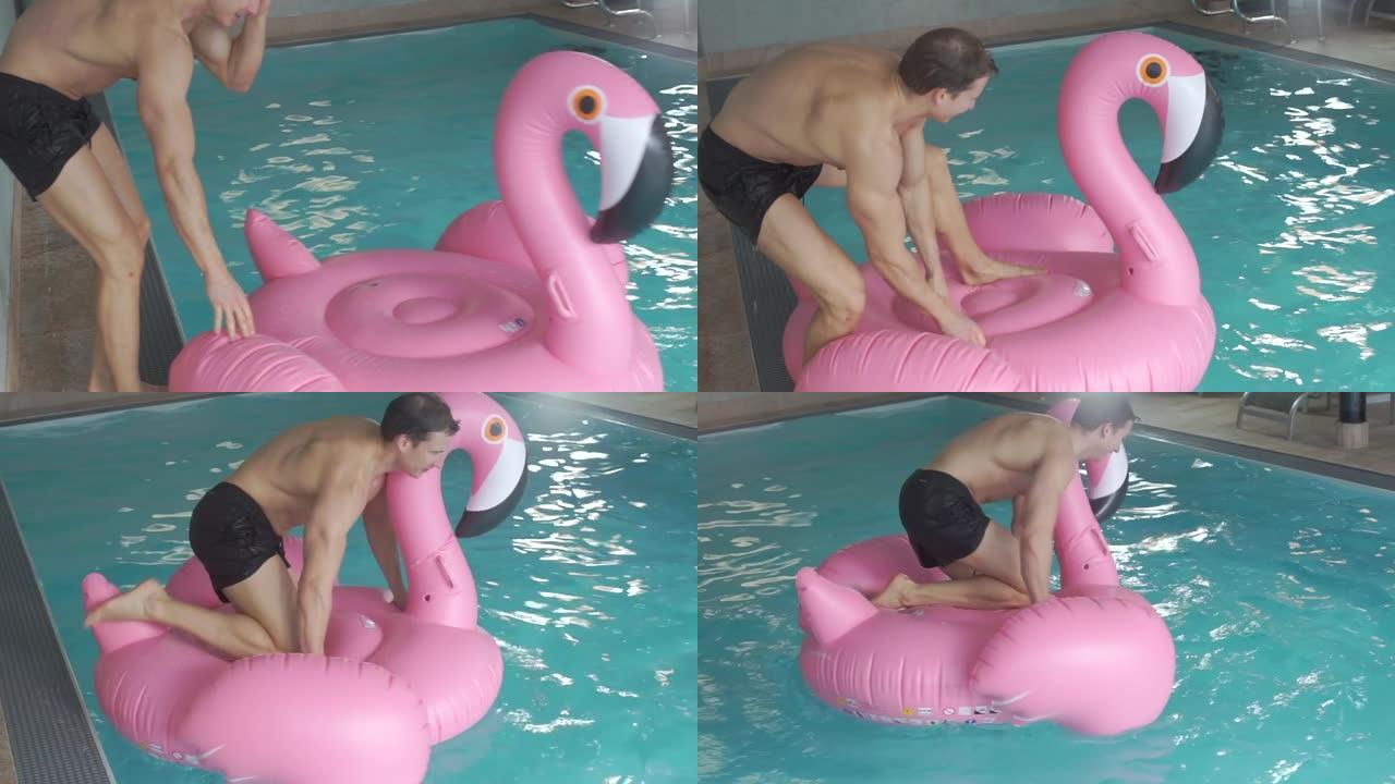 这家伙正试图坐在游泳池里的粉红色火烈鸟上