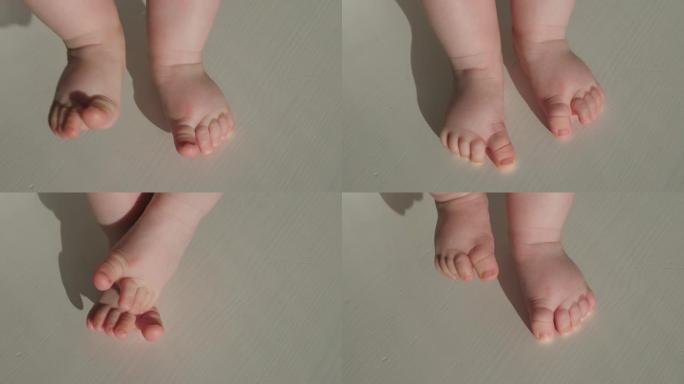 婴儿的第一步。婴儿的裸露脚。白色背景上的小脚趾特写。