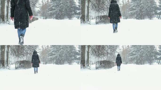 冬日在暴风雪中走到外面的妇女