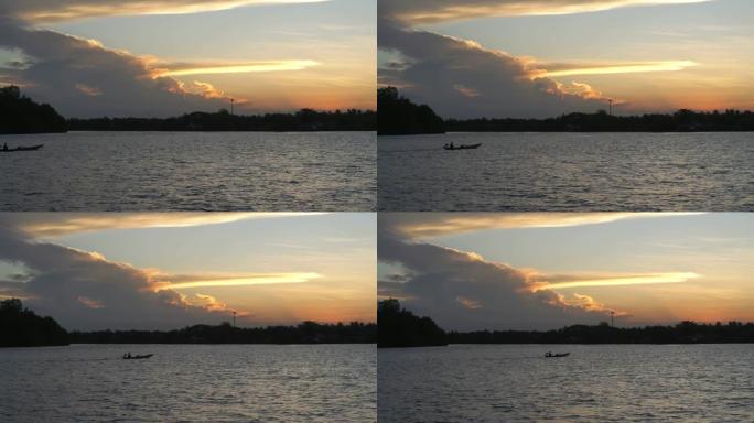 湖上的日落景象，平静的水浪表面荡漾，随着渔船的流动而流动。