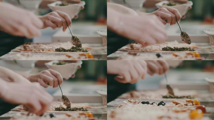 准备意大利披萨奶酪、青香蒜酱、火腿和橄榄。意大利食物，膳食，午餐，美食，餐厅。