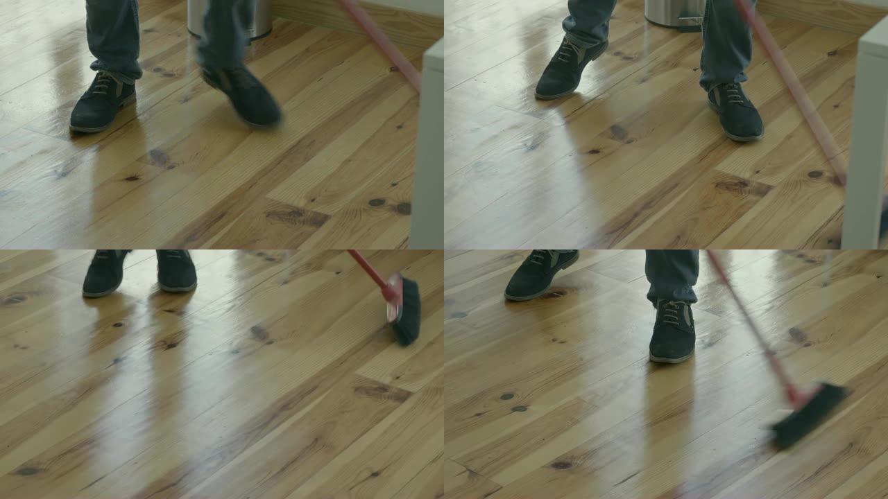 扫帚清洁地板的人的短枪。
