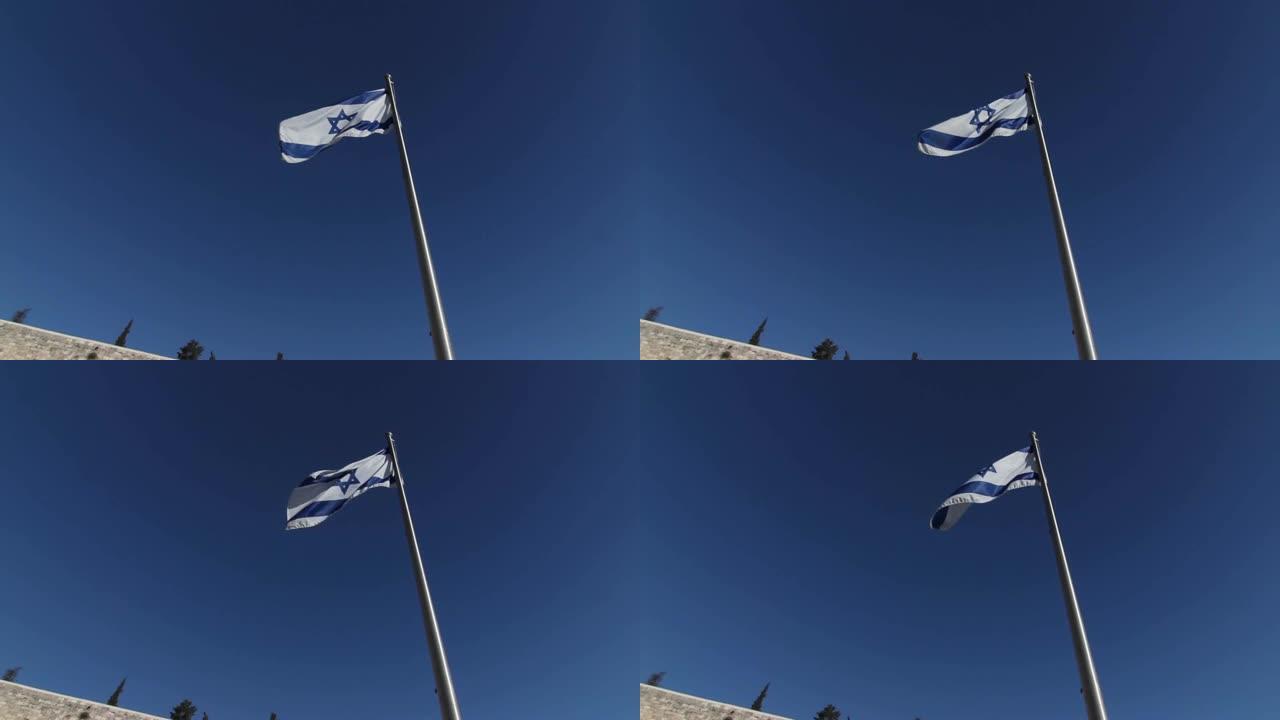 抬头看着西墙附近狂风吹来的以色列国旗