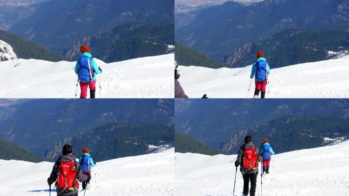 女登山者冬季在雪山峰顶行走