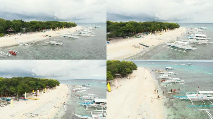 菲律宾保和邦劳巴利卡萨格岛的航拍画面。海滩上的游客，珊瑚礁的壮丽景色，白色海滩，棕榈树，船只/4k无