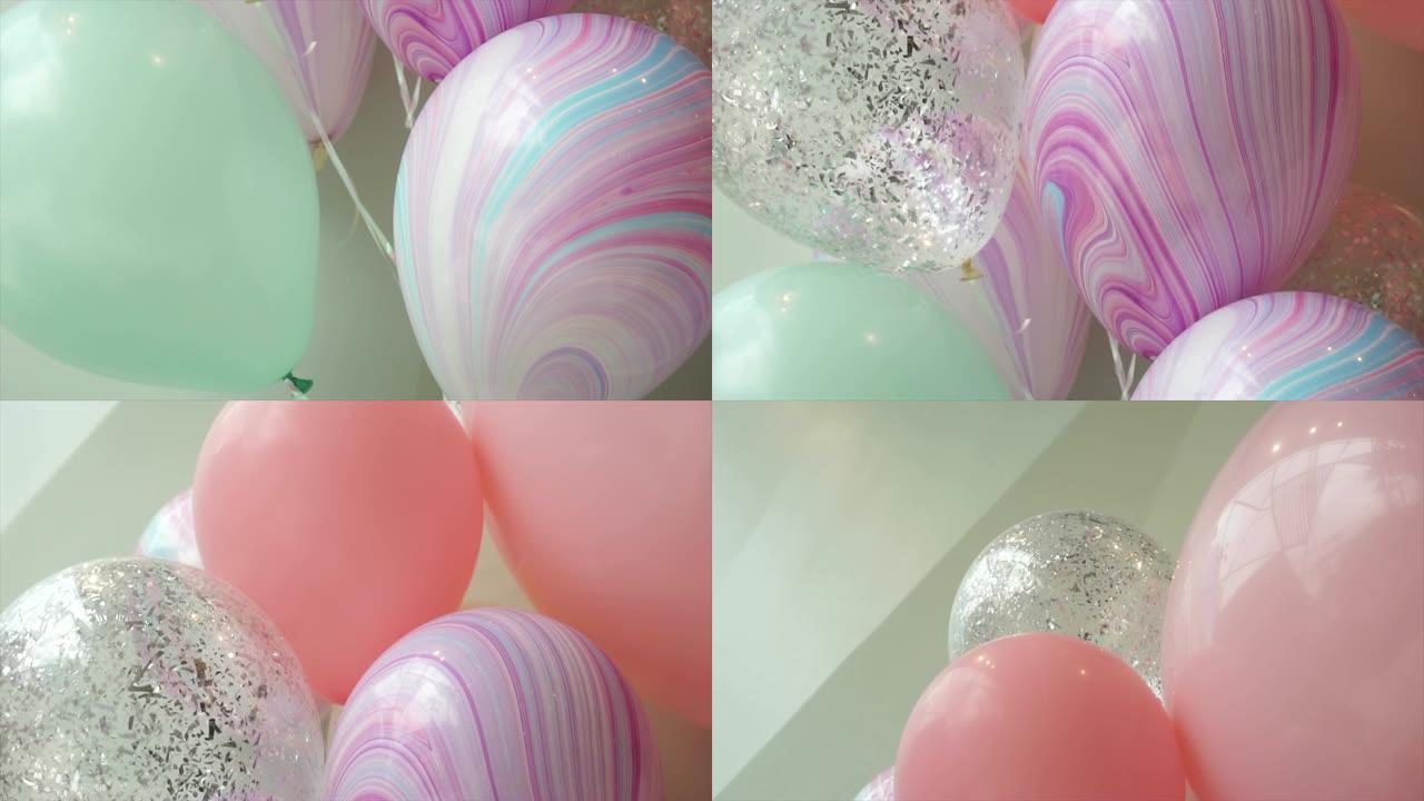 多莉在派对上拍摄了彩色气球。柔和的颜色。节日和生日概念