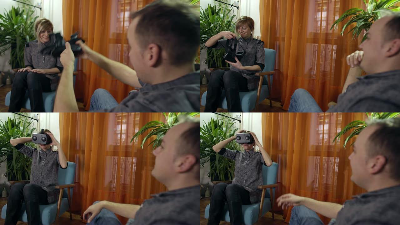 现代扶手椅上的男人和女人在家里共享和享受虚拟现实护目镜