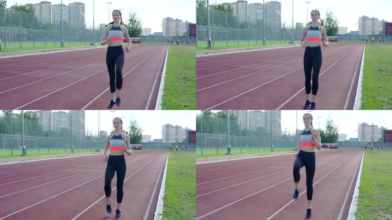 短跑练习前，运动女孩在跑道上做高膝盖运动热身的全程镜头