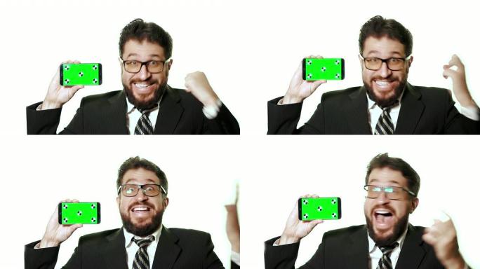 概念性模型。戴着眼镜的大胡子商人拿着带绿屏的智能手机。