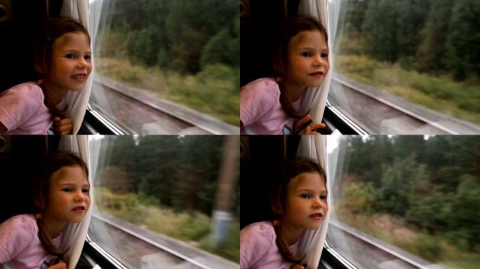 小女孩在火车上透过窗户看