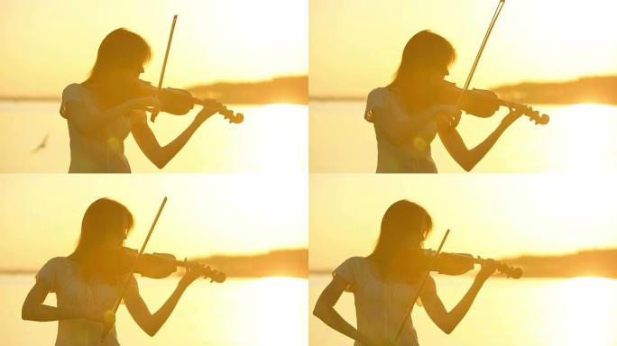 女小提琴手在日落时拉小提琴