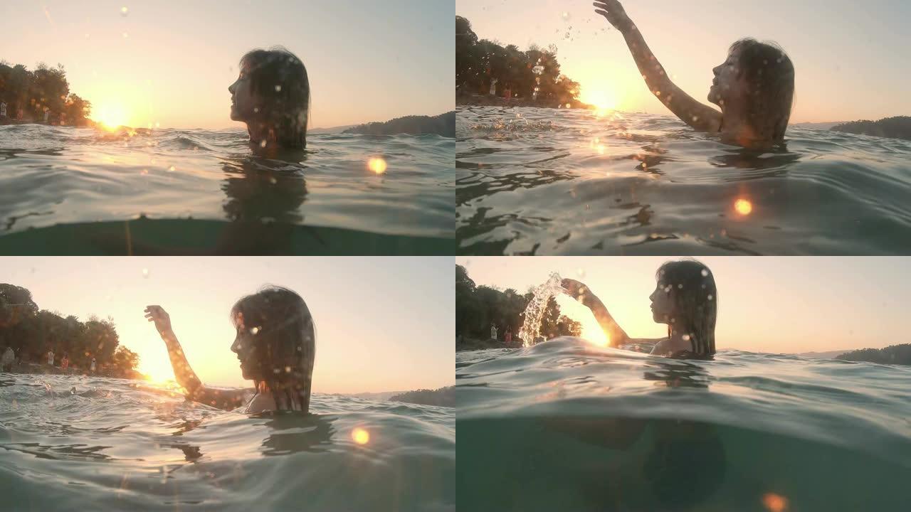 夏天的亚洲女人在水下嬉水和放松日落