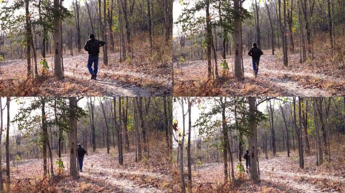 老人摄影师带着春旱走在森林里