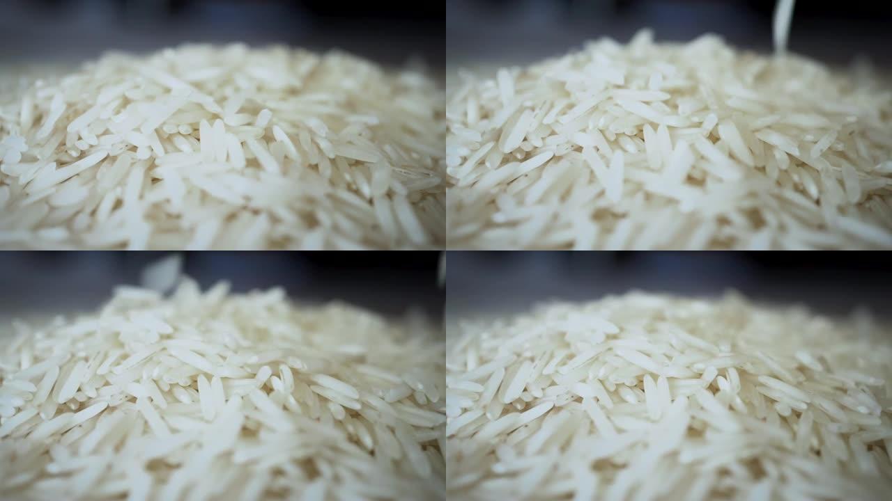 未煮熟的白米在慢动作中掉落成堆的宏观特写