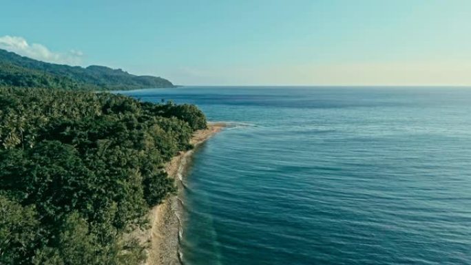 一个偏远的南太平洋岛屿的空中无人机图像，拥有沙滩海岸和美丽的海洋海景和郁郁葱葱的热带雨林丛林