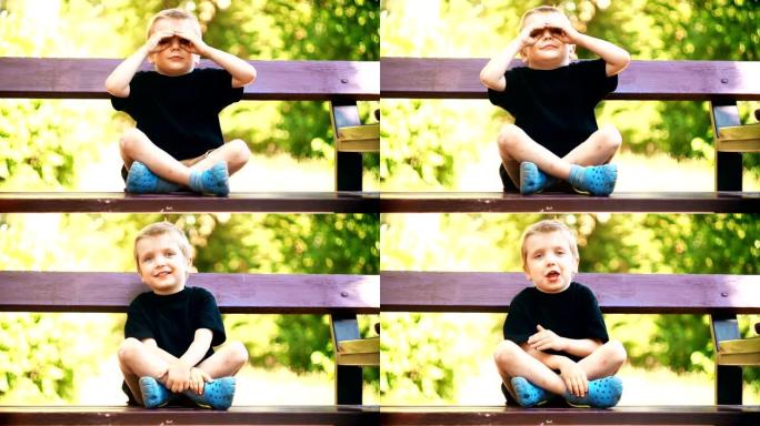 可爱的男孩在公园长椅上玩耍和玩耍。快乐有趣的孩子-股票视频