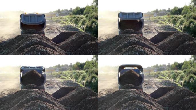 垃圾车的道路工程正在倾倒一堆土壤