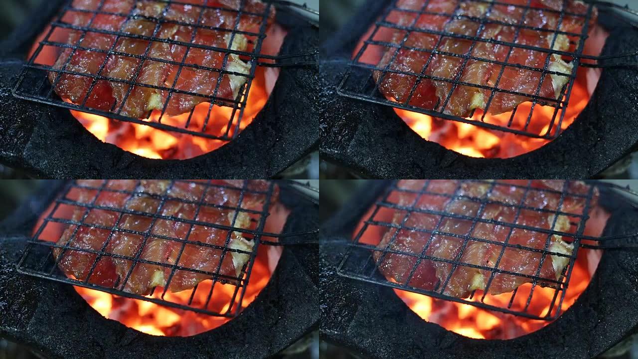 在篝火上烧烤猪肉
