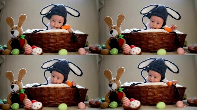刚出生的男婴在篮子里戴着兔子耳朵和尾巴。