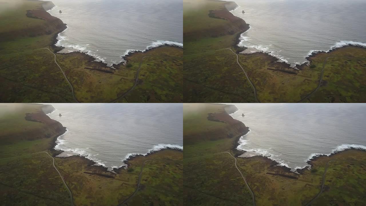 航拍镜头。日出时复活节岛悬崖上的无人机景观。太平洋撞击海岸线和太阳升起地平线上的壮丽景色在一个充满色