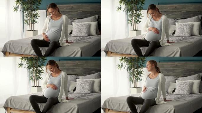 开朗的孕妇在卧室摸肚子