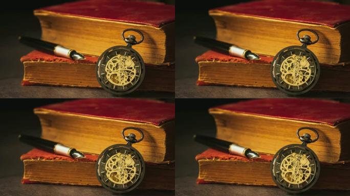 延时缠绕怀表放在旧书和书上的笔旁边。