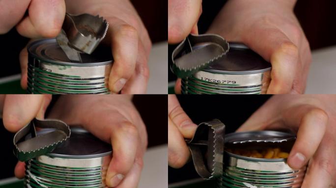 用手动开罐器打开一罐食物并取下盖子顶部的手。