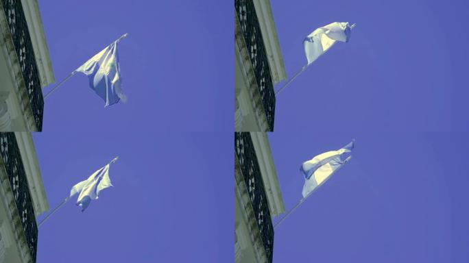 一面以蓝天为背景的阿根廷国旗在阳台上飘扬