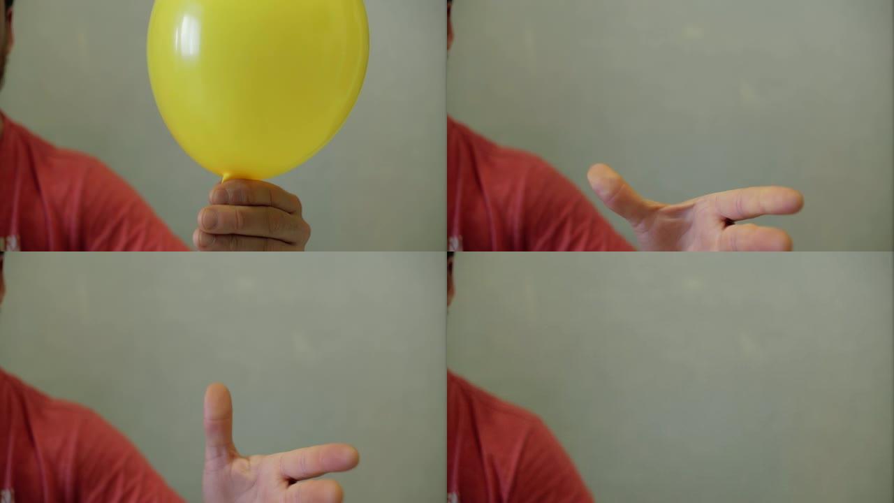 人的手从手中放开黄色气球，球放气并飞走了