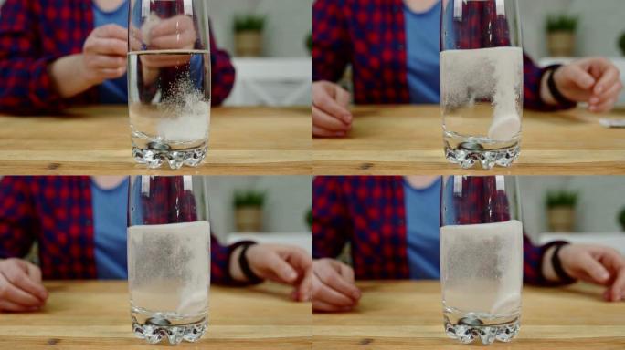 女孩将泡腾片倒入桌上的一杯水中