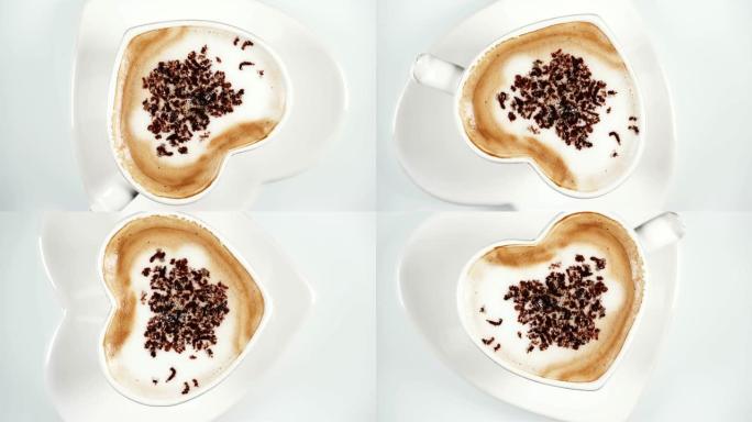 咖啡杯在白色上旋转，自上而下的视图