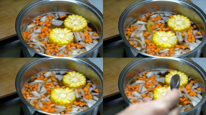女人在锅里煮蔬菜汤。