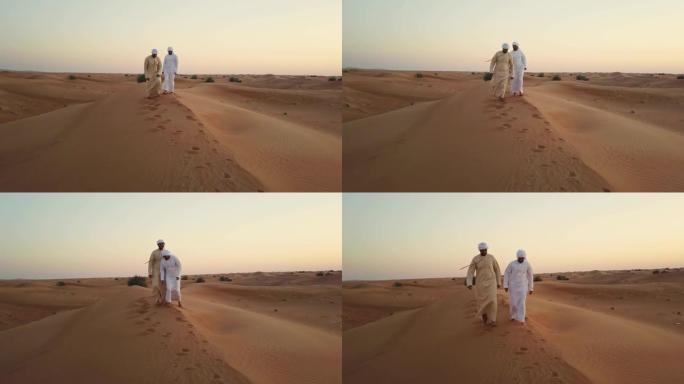 走在沙丘上的阿拉伯人