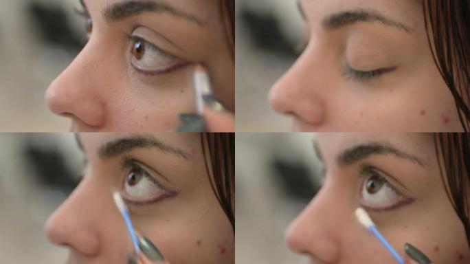 化妆师在年轻女子身上使用眼线笔