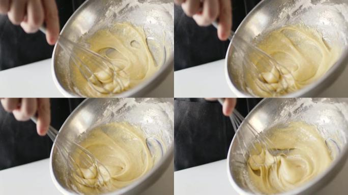 女人准备自制煎蛋卷和打蛋器混合的慢动作作物镜头。