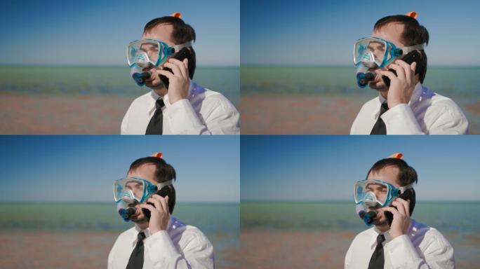 海滩上的商人戴着浮潜面具和浮潜在电话上交谈