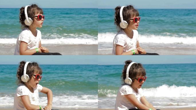 海滩上戴着耳机的有趣孩子。
