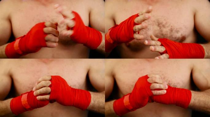 特写男子拳击手用红色包裹勒紧手腕