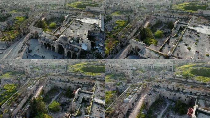 蓝天下阿勒颇废墟清真寺和城市的鸟瞰图。被毁坏的清真寺前人迹罕至，车辆稀少