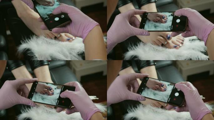 美甲师使用电话为客户的指甲拍照